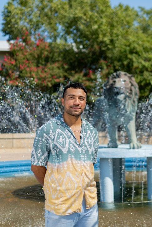 Irv Antonio in front of the lion fountain.